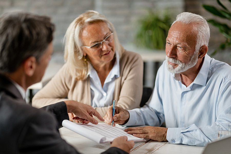 General Medicare - Couple Signing a Contract While Having a Meeting with an Insurance Agent in the Office